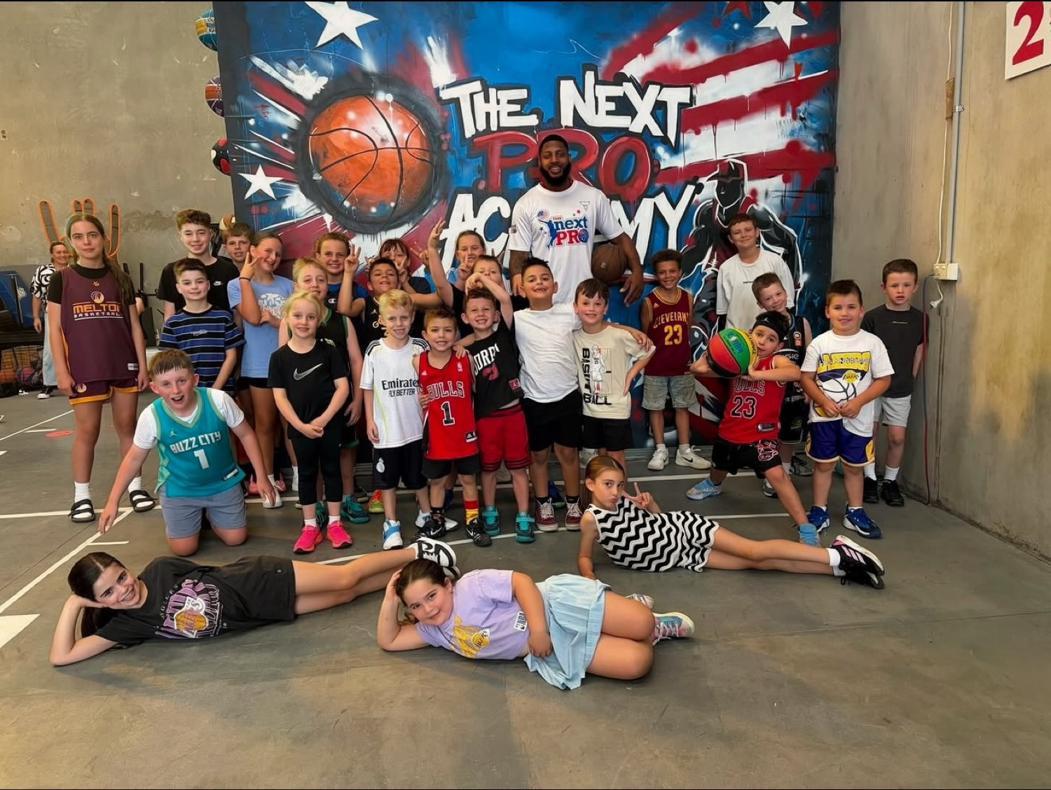 The Next Pro Academy group at the warehouse court